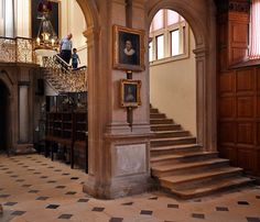 an old building with stairs and paintings on the walls