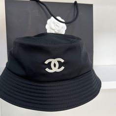 Chanel Black CC Bucket Hat Unworn & 100% authentic guaranteed. DETAILSBlackWhite CC Need assistance? Use our Sourcery service or speak to a member of our team via WhatsApp Bucket Hat Black, Fashion Buyer, Timeless Handbag, Global Style, Chanel Black, Luxe Fashion, Bags Designer Fashion, Exclusive Bag, Personal Shopping