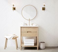 a bathroom with a sink, mirror and stool