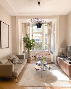 a living room filled with furniture and a flat screen tv