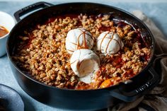 two scoops of ice cream are in a skillet with meatballs and sauce