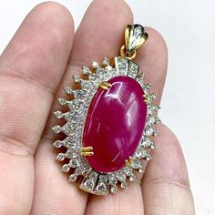 "This gorgeous, vivid, HUGE CABOCHON-Shaped, Burmese Ruby and stunning, impeccably graded F/VS Diamonds will totally melt everyone's heart! EXTREMELY RARE ENORMOUS 40.89 CARATS BURMESE RUBY with ATTRACTIVE, VIVID, HOT-PINKISH-RED color. SET IN FINE 18K SOLID YELLOW GOLD HANDCRAFTED PENDANT! ONLY ONE ITEM AVAILABLE!! WHAT YOU SEE IN THE PICTURES IS WHAT YOU WILL GET   \"You will get the best GEMSTONES from the most experienced GEMS wholesaler in the world.\" SUGGESTED RETAIL VALUE: $35,000 RUBY: Exquisite Ruby Jewelry Gia Certified, Dazzling Gia-certified Ruby Jewelry, Dazzling Gia Certified Ruby Jewelry, Luxury Red Cabochon Necklaces, Luxury Red Cabochon Necklace, Exquisite Red Cabochon Jewelry, Luxury Ruby Pendant Jewelry, Gia Certified Yellow Gold Necklace Gift, Ruby Cabochon Pendant Jewelry