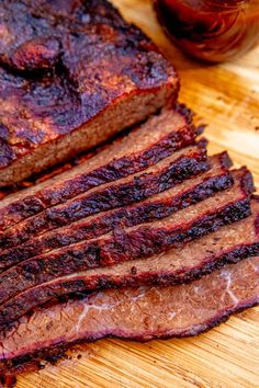 sliced meat sitting on top of a wooden cutting board