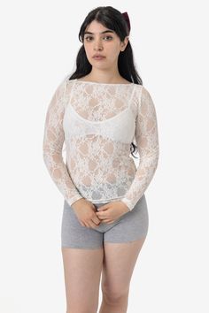 This Floral Lace top is made of stretchy and durable nylon-spandex that is also available in matching skirts, underwear and more. This top has an elegant boatneck and fitted, full-length silhouette. We recommend sizing up for a looser, more relaxed fit. Layer with our cotton spandex bralettes for everyday or pair with our matching lace skirts for an evening out. Made in Los Angeles, Calif. Our experienced sewers earn up to $25 an hour and no less than $17.28; additionally workers have healthcare Lace Knitwear, Matching Skirts, Lace Skirts, Denim Short Jumpsuit, Floral Lace Top, Kids Garments, Floral Lace Tops, Women In Black, Lace Long Sleeve