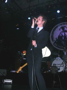 a man in a suit singing into a microphone