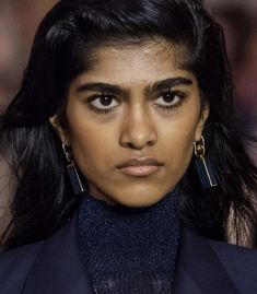 a close up of a person wearing large earrings