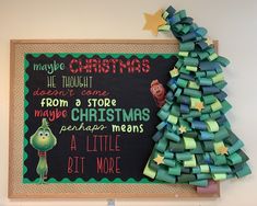 a christmas tree is next to a chalk board