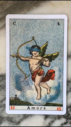 a tarot card with an image of a cupid holding a bow and arrow