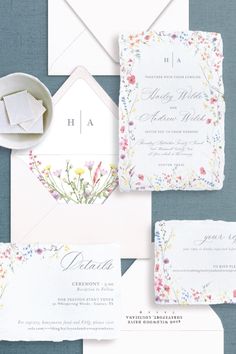 the wedding stationery is laid out on top of each other