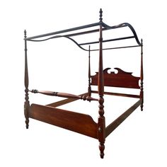 a wooden bed frame with an iron headboard and foot board on the sides, against a white background