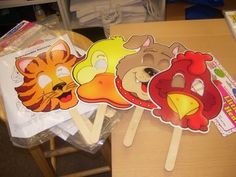 three animal masks sitting on top of a wooden table