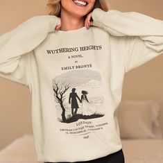 Introducing the must-have piece for all bookworms, literature lovers, and Emily Bronte fans - the Wuthering Heights sweatshirt! This unique and stylish sweatshirt features the first page of Chapter 1 on the back. If you are a Wuthering Heights lover or simply appreciate classic literature, this sweatshirt is a must-have addition to your wardrobe. Featuring a one-of-a-kind design, this Wuthering Heights sweatshirt showcases a special touch with the first chapter printed on the back. It's the perf Literary Long Sleeve Cotton Tops, Relaxed Fit Crew Neck Bookish Sweatshirt, Literary Long Sleeve Tops With Letter Print, Bookworm Gifts, Literary Shirts, Emily Brontë, Emily Bronte, Wuthering Heights, Literary Gifts