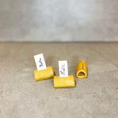 three pieces of yellow tape are sitting on the floor next to each other, with one piece missing