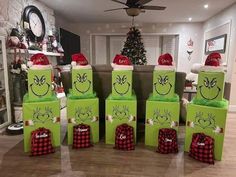 green boxes with faces drawn on them are sitting in the middle of a living room