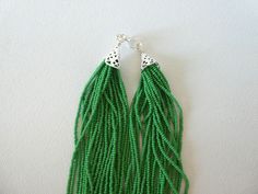 "This stunning kelly green necklace is perfect for that summer dress, beach wedding, date night, and many more special occasions. Available with silver or gold clasp. It looks very elegant and the color is very classic It has 24 strands. Please read specifications on SIZES below. This item comes in several sizes. Kindly choose at checkout. You can use the diagram on the pictures as a reference, but keep in mind that we all have different neck and body sizes so I recommend you measure yourself to Green Multi-strand Necklace With Tiny Beads, Elegant Green Beaded Necklaces With Dangling Beads, Elegant Green Beaded Necklace With Tiny Beads, Green Multi-strand Beaded Necklace For Gift, Green Multi-strand Beaded Necklace As Gift, Green Tiny Multi-strand Beads, Summer Dress Beach, Green Statement Necklace, Necklace Green