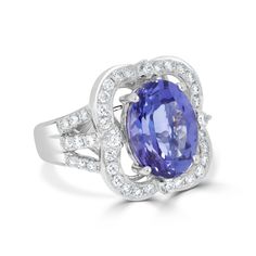 13x10 Violetish Blue AAAA Tanzanite Ring Oval shape 6.40 ct with 0.85 cttw Diamond in 14K White Gold. Product Information SKU TT1010/3 Metal Type 14K Metal Color White Gold Ring Style - Primary Stone Gemstone Name Tanzanite Gemstone Species Zoisite No. of Gemstones 1 Gemstone Grades AAAA Gemstone Shape Oval Gemstone Weight 6.40 Gemstone Size 13x10 Origin Tanzania Secondary Stone Gemstone Name Diamond Gemstone Species Diamond No. of Gemstones 46 Gemstone Grades - Gemstone Shape Round Gemstone Wei Gia Certified Oval Tanzanite Diamond Ring, Gia Certified Tanzanite Oval Rings, Gia Certified Oval Tanzanite Ring, Oval Tanzanite Diamond Ring With Accent Stones, Oval Tanzanite Rings Fine Jewelry, Oval Tanzanite Gemstones In Prong Setting, Oval Tanzanite Gemstones For Formal Occasions, Oval Diamond Ring With Gemstone Accents For Formal Occasions, Tanzanite Ring