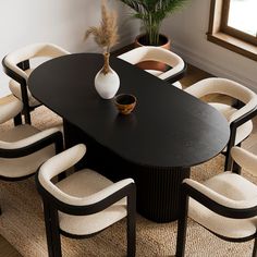 a black table with white chairs around it