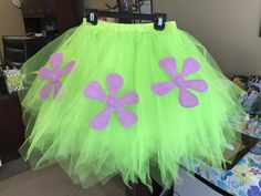 a green tutu skirt with pink flowers on the front and purple petals on the back