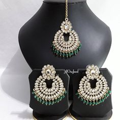 Beautiful handcrafted large earrings and tikka set gold polished decorated with Pearls and kundan stones finished with coloured beading will stand out in any function . Women can be worn as your daily earrings or party wear comes with lovely tikka. Earrings Size: L x 6.5cm / W x 4.8cm Tikka: L x 6.5cm/ W x 4.8cm + chain Total Weight: 33 gram (10g for 1 earrings)  Stone Colour: Clear White  Pearl Colour: Green Green Tilla Earrings For Gift, Green Tilla Earrings As Gift, Handmade Bollywood Ceremonial Earrings, Handmade Bollywood Earrings For Ceremonial Occasions, Traditional Dangle Tikka As Gift, Handmade Elegant Chandbalis For Ceremonial Occasions, Handmade Elegant Chandbalis For Ceremonial Events, Kundan Tikka With Matching Earrings As Gift, Ceremonial Handmade Kundan Earrings