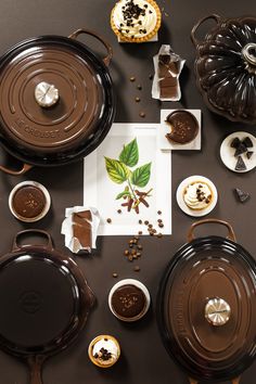 chocolate desserts and pastries are arranged on a table