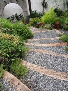 a stone path in the middle of a garden