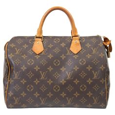 100% Authentic  This classic handbag is finely crafted of traditional Louis Vuitton monogram coated canvas. The bag features vachetta cowhide leather trim and rolled top handles with polished brass hardware. The top zipper opens to a cocoa brown fabric interior with a hanging pocket. Base length: 13.75 in Height: 9.25 in Width: 7.25 in Drop: 3.5 in Very Good Condition- Darkening of leather and marks to exterior and interior See photos OQS530053 NM9.11.24 Known for its impeccable style and qualit Louis Handbags Vuitton, Speedy 35, Louis Vuitton Brown, Classic Handbags, Cocoa Brown, Brown Fabric, French Design, Canvas Leather, Brass Hardware