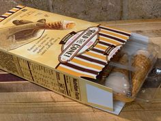 an open box of cookies sitting on top of a wooden table