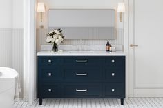 a bathroom with blue cabinets and white walls