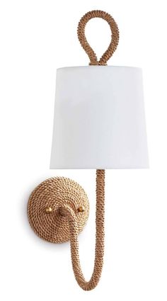 a rope lamp with a white shade on the side and a cord attached to it