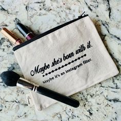 two makeup brushes sitting on top of a white bag