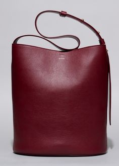 The Norma Tote in Burgundy Red embodies the philosophy of ‘storing it all', disguised in an encounter between elegance, minimalism, and functionality. Inevitably inspired by the love and lust for travelling, The Norma Tote will carry you through the busy everyday on the go, from grocery shopping to dinner parties. With meticulously designed details, this bag effortlessly complements any outfit while offering a spacious interior that accommodates your daily essentials. From computer and paperwork Burgundy Tote Bag, Burgundy Bag, Instagram Jewelry, Versatile Jewelry, Work Tote, Love And Lust, Timeless Jewelry, Daily Essentials, Wallet Bag