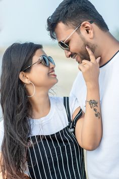 a man and woman standing next to each other with their hands on their foreheads