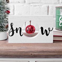 a christmas ornament with the word snow on it