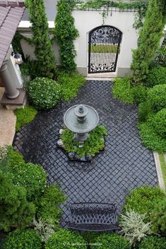 an aerial view of a garden with a fountain