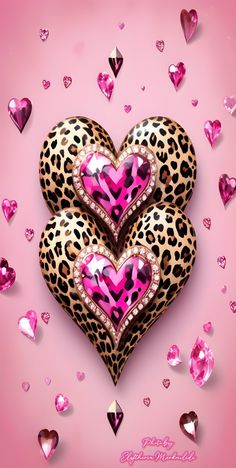 two heart shaped brooches with pink and black hearts in the middle on a pink background