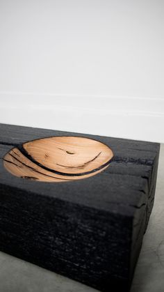 a wooden object that has been carved to look like a bowl on top of it