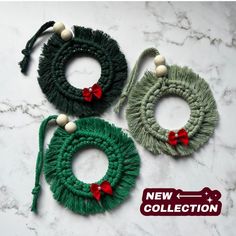 three green wreaths with red bows are on a marble surface and one is for sale