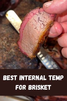 a hand holding a piece of meat with the words best international temp for brisket