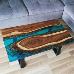 a coffee table made out of wood with blue paint on the top and bottom part