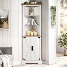 a living room with a white bookcase next to a chair and potted plant