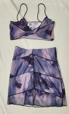 Princess Polly The Bella 2-Piece Set New with Tag. New Condition. Retail: $68.00 Color: Purple Tie-Dye Size: US 4 - EU 36 - AU/UK 8 Matching set Slim fitting Mesh material Overlocked contrast stitching Crop top, Twisted bust Elasticated shoulder straps High waisted mini skirt Elasticated waistband Invisible zip fastening at back Good stretch   Fully lined 95% polyester 5% elastane Imported High Waisted Mini Skirt, Purple Tie Dye, Purple Tie, Invisible Zip, Mesh Material, Good Stretches, Princess Polly, Matching Sets, Color Purple