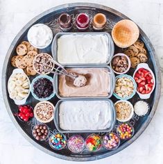 a platter filled with lots of different foods and dips on top of it