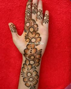 the hand is decorated with flowers and leaves