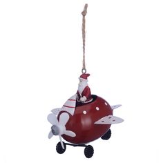 an ornament shaped like a plane with santa on it's back hanging from a rope