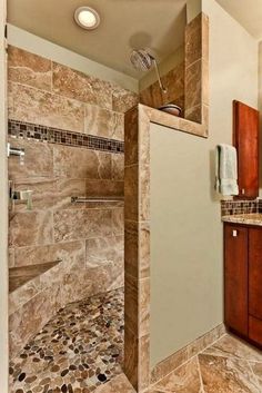 a walk in shower sitting inside of a bathroom next to a sink and counter top