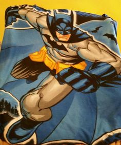 a close up of a batman blanket on a bed