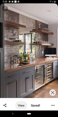 a kitchen filled with lots of counter top space next to a tv mounted on a wall