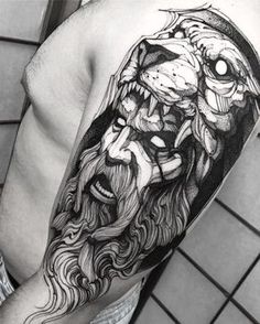 a man with a lion head tattoo on his arm and shoulder is shown in this black and white photo