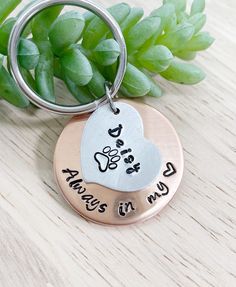 a keychain with two hearts and the words always in my heart on it