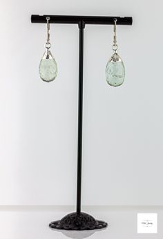 These pretty Silver Leafed Seafoam Green Prasiolite Drop Earrings from Miel Jewelry Shop are a lovely addition to your jewelry collection. They feature sterling silver lever backs that support a big beautiful, dimensional seafoam green prasiolite gemstone. The unique leaf design adds a touch of elegance and sophistication to the large natural prasiolite drop. Sparkling, faceted silver-leafed, light seafoam green, pear-shaped prasiolite drops. Sterling silver lever backs for a secure and comforta Statement Earrings Silver, Boho Chic Jewelry, Gemstone Jewelry Handmade, Chic Jewelry, Raw Gemstones, Seafoam Green, Everyday Jewelry, Boho Chic Fashion, Handmade Artisan